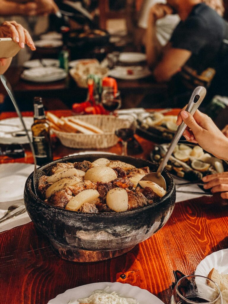 Gourmet meal shared among friends in a rustic restaurant setting. A blend of flavors and good company.